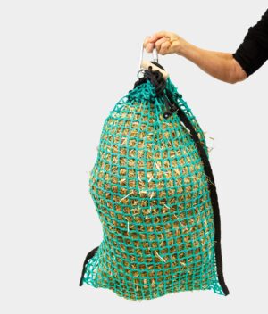 A green Forageplus small-holed hay net filled with hay