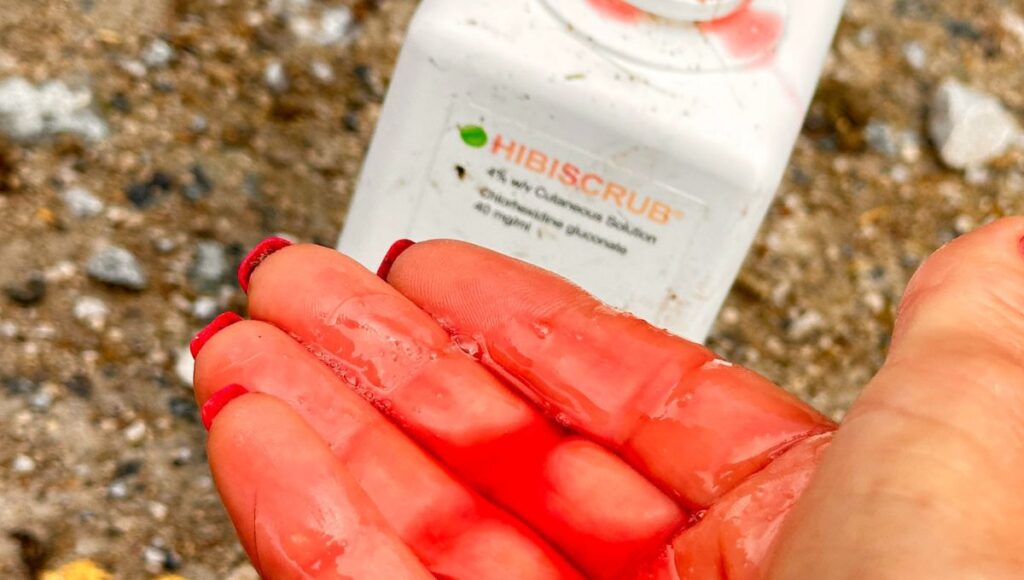 Hand holding Hibiscrub antibacterial horse shampoo 